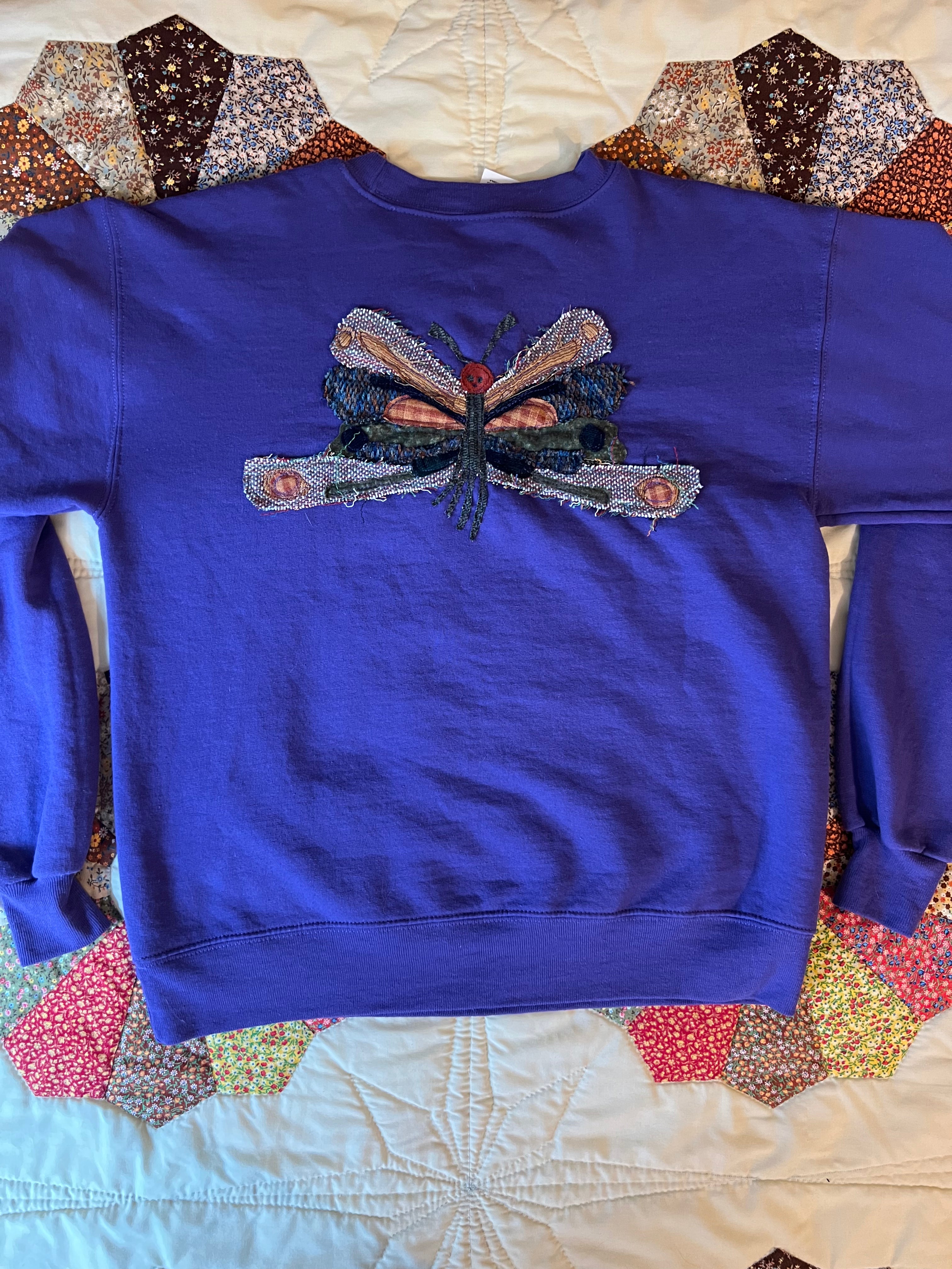purple crewneck with butterfly