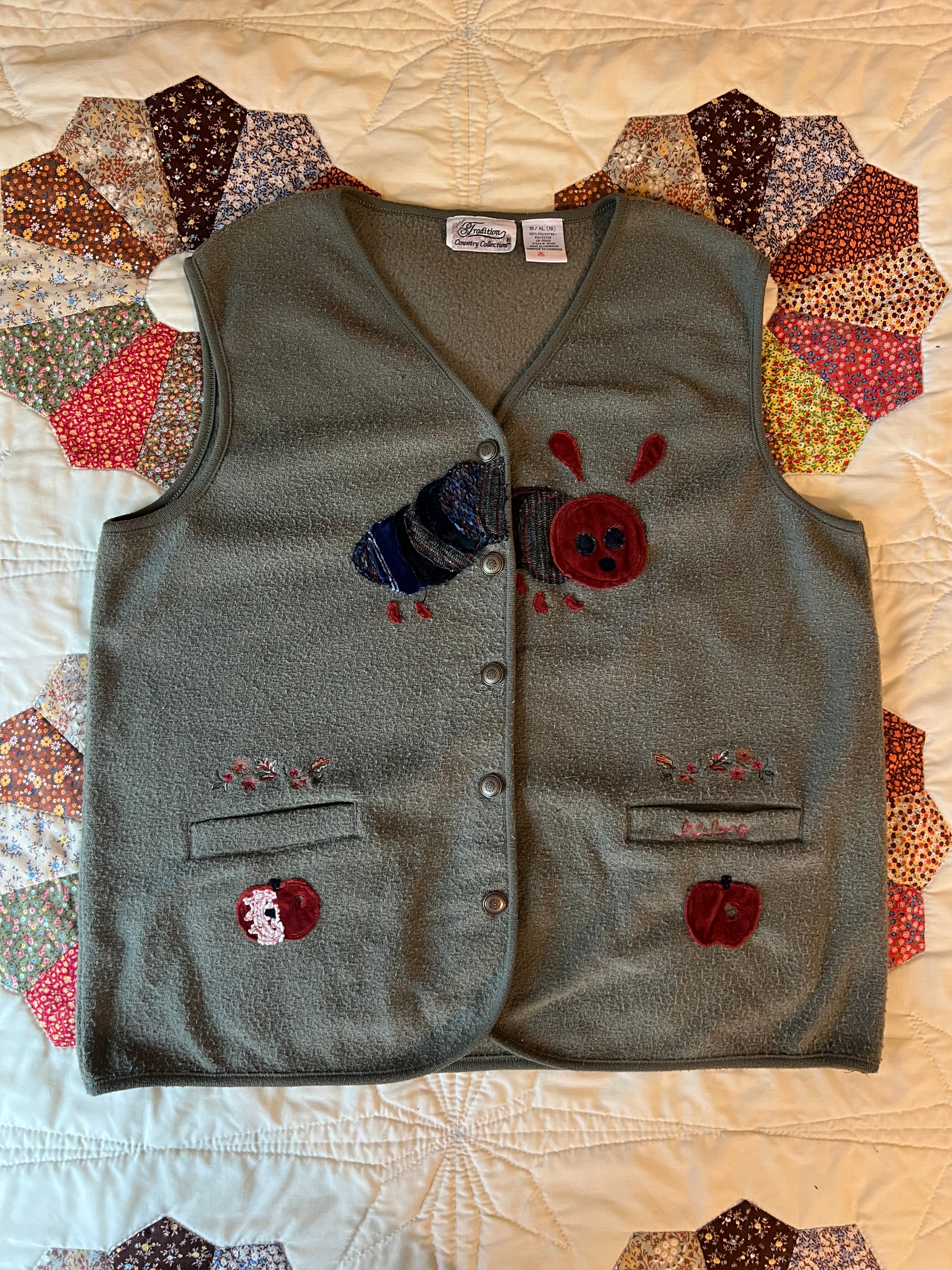 green vest with apples