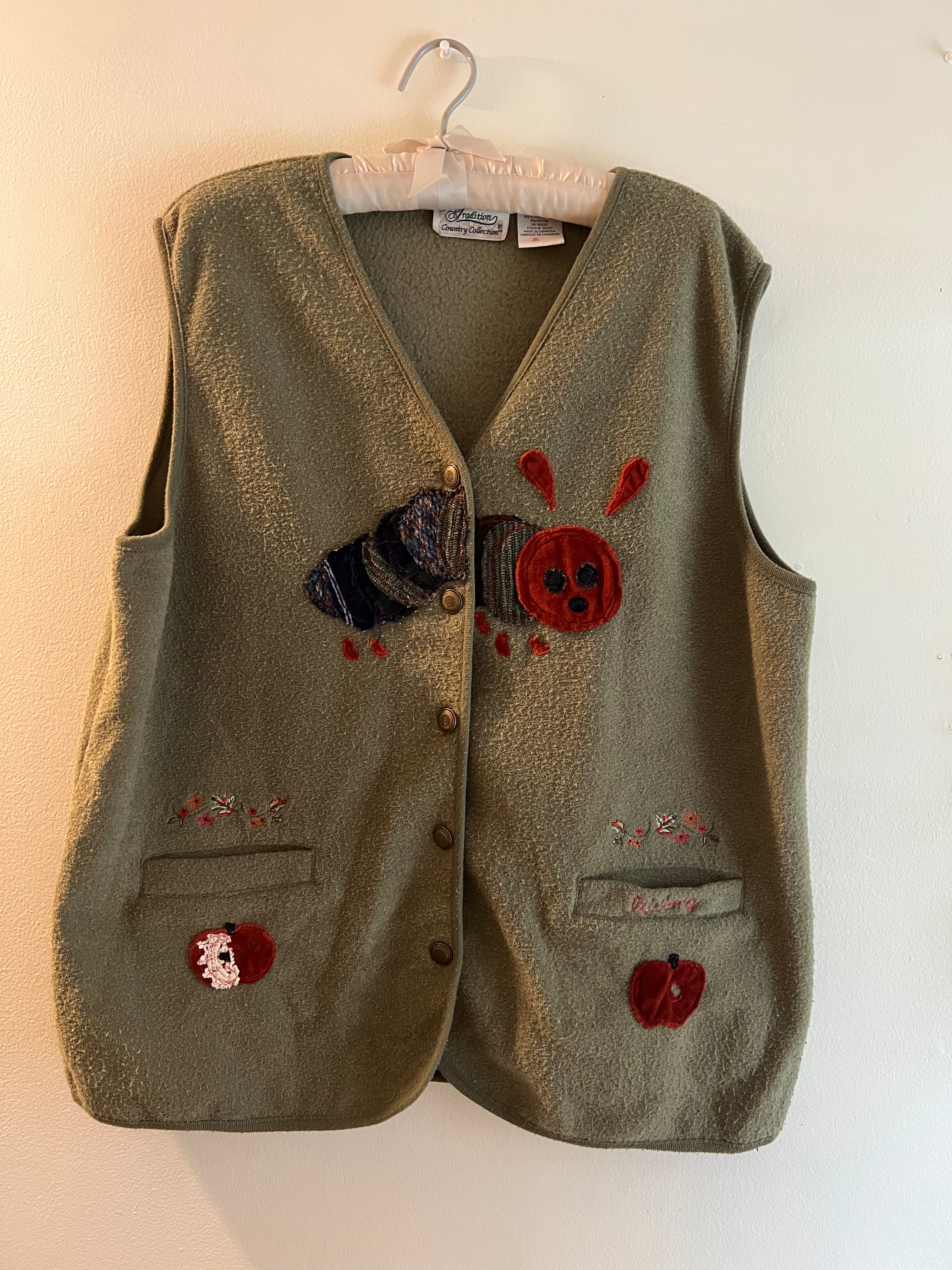 green vest with apples