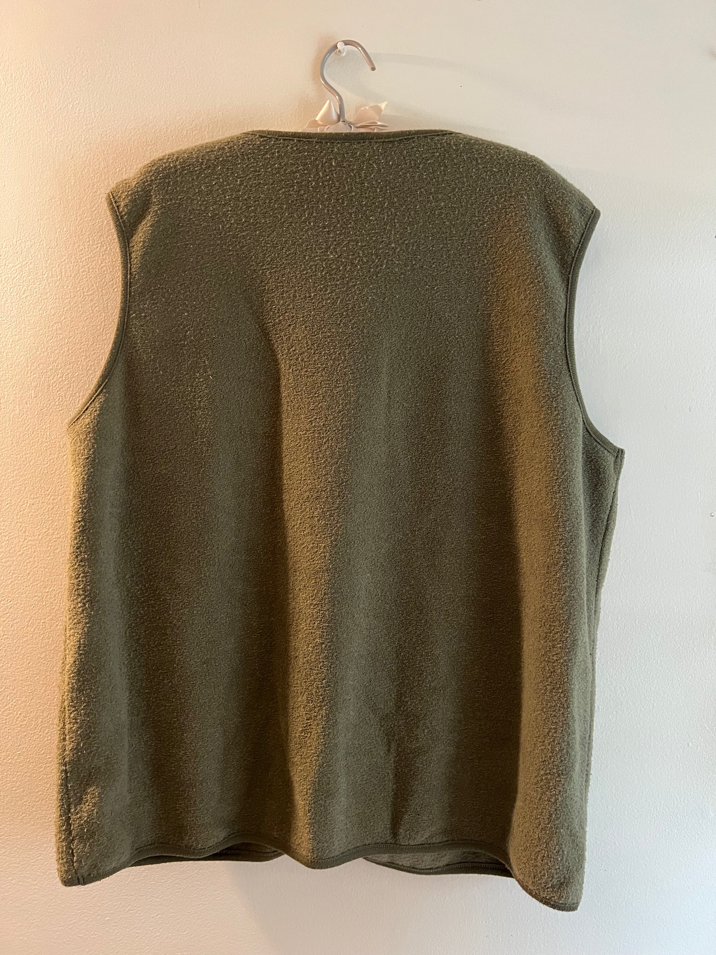 green vest with apples